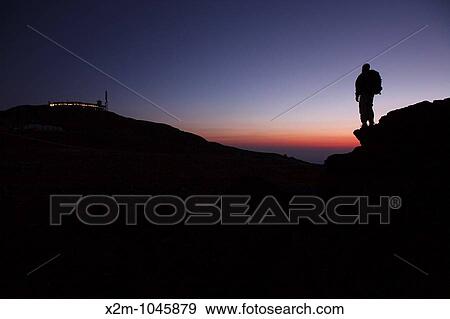 A hiker takes in the view of Mount Washington at sunset from Ball Crag Located in the White Mountains, New Hampshire USA Notes: Mount Washington is famous for the highest wind gust ever measured on earth at 231 miles per hour on April 12, 1934 View Large Photo Image Stock Photo - A hiker takes in the view of Mount Washington at sunset from Ball Crag Located in the White Mountains, New Hampshire USA Notes: Mount Washington is famous for the highest wind gust ever measured on earth at 231 miles per hour on April 12, 1934. Fotosearch