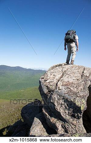 A hiker takes in the views of Franconia Notch from the summit of Mount Liberty during the summer months Located in the White Mountains, New Hampshire USA View Large Photo Image Stock Photo - A hiker takes in the views of Franconia Notch from the summit of Mount Liberty during the summer months Located in the White Mountains, New Hampshire USA. Fotosearch
