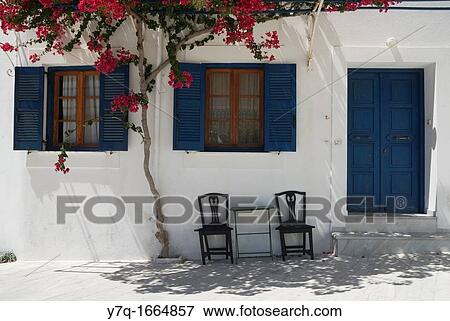 Stock Photo - A home deciorated with blooming bougainvillia inA home decorated with blooming bougainvillea in the hill town of Lefkes, Paros Island, Cyclades, Greece the hill town of Lefkes, Paros Island, Cyclades, Greece. Fotosearch