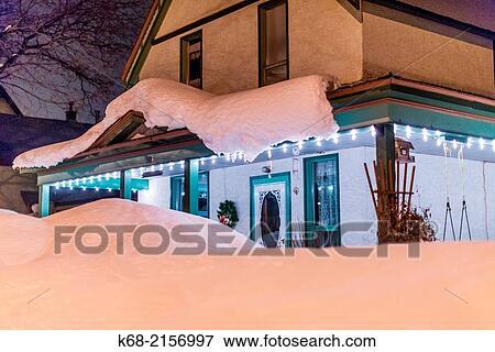 A house surrounded by snow at night, in Revelstoke, BC, Canada. View Large Photo Image Stock Photo - A house surrounded by snow at night, in Revelstoke, BC, Canada.. Fotosearch