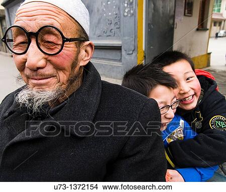 A Hui Muslim man with his two grandchildren View Large Photo Image Picture - A Hui Muslim man with his two grandchildren. Fotosearch
