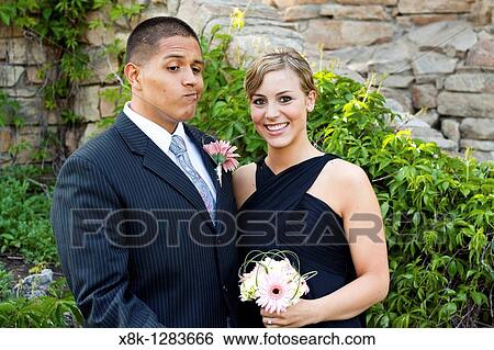 A husband and wife pose for a formal photo, the husband hams it up to look unsure View Large Photo Image Stock Photograph - A husband and wife pose for a formal photo, the husband hams it up to look unsure. Fotosearch