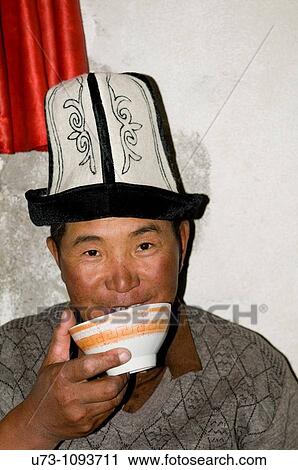 A Kyrgyz man drinking a cup of mare's milk. View Large Photo Image Stock Image - A Kyrgyz man drinking a cup of mare's milk.. Fotosearch