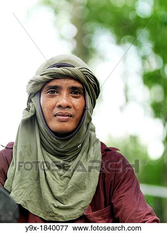 A labor worker on his motor bike towing equipment at Tanjung Piai National Park View Large Photo Image Stock Photo - A labor worker on his motor bike towing equipment at Tanjung Piai National Park. Fotosearch
