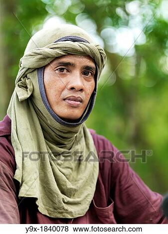 A labor worker on his motor bike towing equipment at Tanjung Piai National Park View Large Photo Image Stock Photo - A labor worker on his motor bike towing equipment at Tanjung Piai National Park. Fotosearch