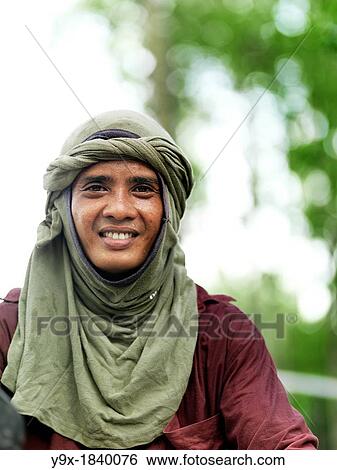 A labor worker on his motor bike towing equipment at Tanjung Piai National Park View Large Photo Image Stock Photograph - A labor worker on his motor bike towing equipment at Tanjung Piai National Park. Fotosearch