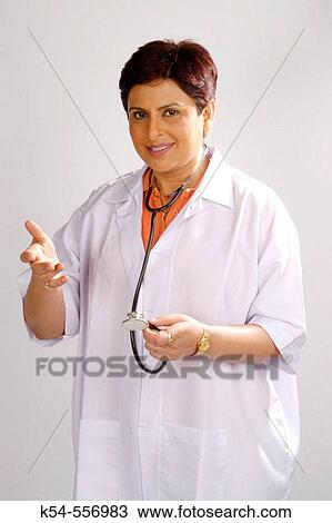 Stock Image - A lady doctor with a smile on her face.. Fotosearch