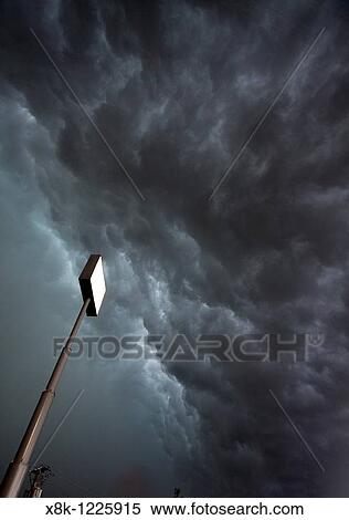 A large sign stands against the roiling clouds of a severe squall line overhead in Nebraska, May 24, 2010 View Large Photo Image Stock Photography - A large sign stands against the roiling clouds of a severe squall line overhead in Nebraska, May 24, 2010. Fotosearch