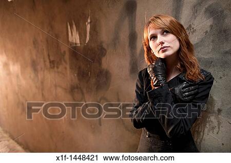 Stock Image - A late teen early 20s single woman girl with red hair, UK. Fotosearch