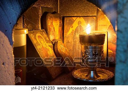 A lit candle and Icons inside a Religious Shrine ( Eklisaki ) Crete, Greece. View Large Photo Image Stock Image - A lit candle and Icons inside a Religious Shrine ( Eklisaki ) Crete, Greece.. Fotosearch