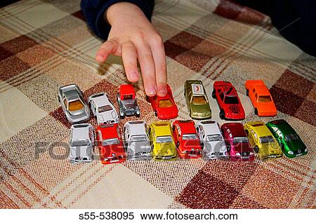 A little boy of 5 years playing with toy cars and cars of chocolate presented to him by his grandmother. While playing, sometimes eats one or two cars, all the time reducing the number of cars. View Large Photo Image Stock Photography - A little boy of 5 years playing with toy cars and cars of chocolate presented to him by his grandmother. While playing, sometimes eats one or two cars, all the time reducing the number of cars.. Fotosearch