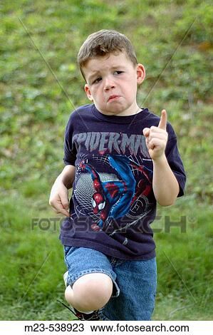 Stock Image - A little boys dances to imaginary music. Fotosearch