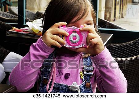 A little girl plays at being a photographer View Large Photo Image Stock Photography - A little girl plays at being a photographer. Fotosearch