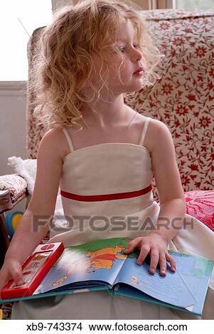 A little girl reading a book with sound effects View Large Photo Image Picture - A little girl reading a book with sound effects. Fotosearch