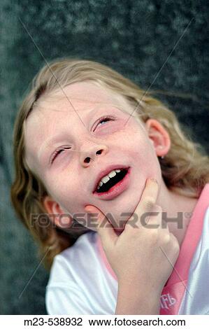 A little girl thinks hard and with humor on a subject View Large Photo Image Stock Image - A little girl thinks hard and with humor on a subject. Fotosearch