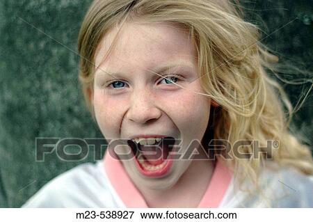 Stock Photo - A little girl yells with joy. Fotosearch