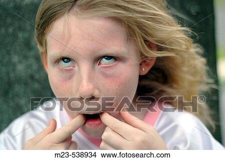 Picture - A little girls makes a funny face. Fotosearch