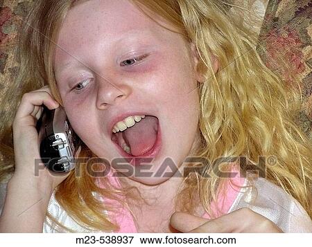 A little girls yaks on the phone View Large Photo Image Stock Photo - A little girls yaks on the phone. Fotosearch