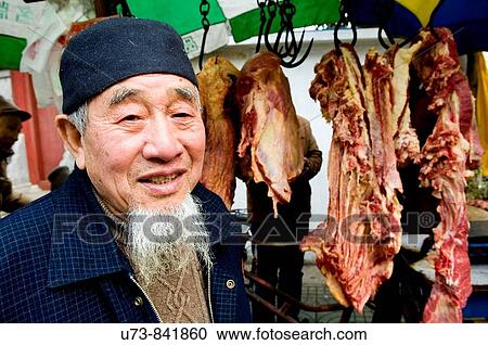 A local Muslim Chinese stands next to his butcher shop near one of the mosques of Nanjing, China View Large Photo Image Stock Image - A local Muslim Chinese stands next to his butcher shop near one of the mosques of Nanjing, China. Fotosearch