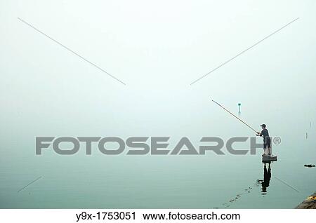 A lone fisherman at at West Lake in Hanoi, Vietnam View Large Photo Image Stock Image - A lone fisherman at at West Lake in Hanoi, Vietnam. Fotosearch