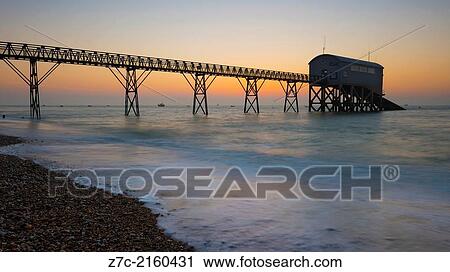 A long exposure of selsey bill beach showing the lifeboat staion an a misty morning at dawn. View Large Photo Image Stock Image - A long exposure of selsey bill beach showing the lifeboat staion an a misty morning at dawn.. Fotosearch