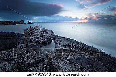 A long exposure of Split Rock at Clachtoll Bay as the sun sets over the Scottish Highlands. View Large Photo Image Stock Image - A long exposure of Split Rock at Clachtoll Bay as the sun sets over the Scottish Highlands.. Fotosearch