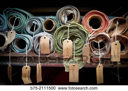 a lot of fabric rolls in a warehouse, with a description and a price per meter in London, England, UK, Europe. View Large Photo Image Stock Image - a lot of fabric rolls in a warehouse, with a description and a price per meter in London, England, UK, Europe.. Fotosearch