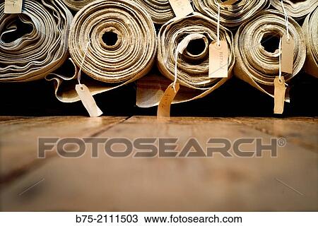 a lot of fabric rolls in a warehouse, with a description and a price per meter in London, England, UK, Europe. View Large Photo Image Stock Image - a lot of fabric rolls in a warehouse, with a description and a price per meter in London, England, UK, Europe.. Fotosearch