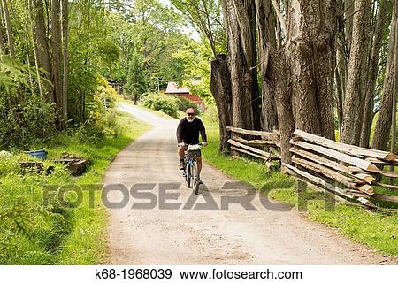 A man, 75, bicycles on Saturna Island, Gulf Islands, British Columbia, Canada View Large Photo Image Stock Photo - A man, 75, bicycles on Saturna Island, Gulf Islands, British Columbia, Canada. Fotosearch