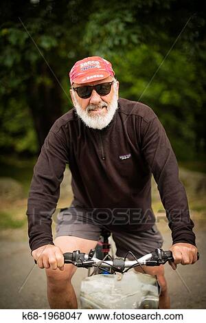 A man, 75, bicycling on Saturna Island, Gulf Islands, British Columbia, Canada View Large Photo Image Stock Photo - A man, 75, bicycling on Saturna Island, Gulf Islands, British Columbia, Canada. Fotosearch
