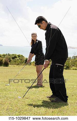 a man and a woman golfing View Large Photo Image Stock Photo - a man and a woman golfing. Fotosearch