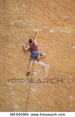 Picture - A man climbs a rock face in Smith Rock State Park. Oregon, USA. Fotosearch