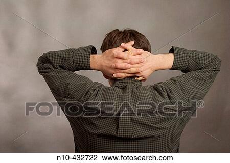 A man from the mid-back up as seen from the rear, with his hands clasped together on the back of his head View Large Photo Image Stock Image - A man from the mid-back up as seen from the rear, with his hands clasped together on the back of his head. Fotosearch