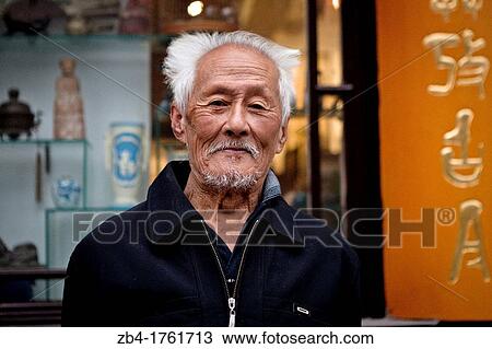 A man in front of a a shop in Liulichang street, Beijing, China, Asia. View Large Photo Image Stock Image - A man in front of a a shop in Liulichang street, Beijing, China, Asia.. Fotosearch