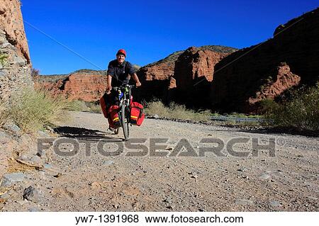 A man is cycling in Calchaqui valley, Salta province, Argentina View Large Photo Image Stock Photo - A man is cycling in Calchaqui valley, Salta province, Argentina. Fotosearch