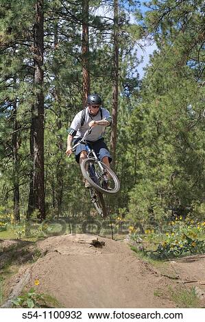 A man jumping on his mountain bike at Camp Sekani Park, Beacon Hill, Spokane, Washington, USA View Large Photo Image Stock Image - A man jumping on his mountain bike at Camp Sekani Park, Beacon Hill, Spokane, Washington, USA. Fotosearch
