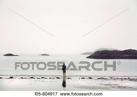 A man looking at the Pacific Ocean at Tofino, Vancouver Island, British Columbia, Canada View Large Photo Image Stock Photo - A man looking at the Pacific Ocean at Tofino, Vancouver Island, British Columbia, Canada. Fotosearch