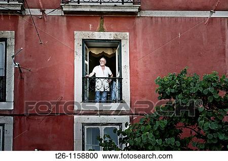 a man looks from his window in the Alfama district. Lisbon, Portugal View Large Photo Image Stock Image - a man looks from his window in the Alfama district. Lisbon, Portugal. Fotosearch