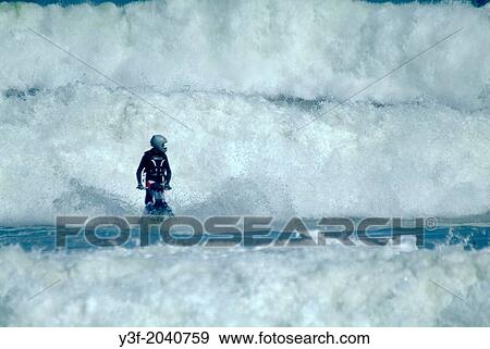 A man on a jet ski surfs big waves. Cape Town, South Africa View Large Photo Image Stock Photo - A man on a jet ski surfs big waves. Cape Town, South Africa. Fotosearch