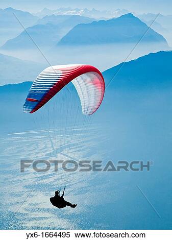 A man paragliding in the Swiss Alps near Mount Rigi View Large Photo Image Stock Photography - A man paragliding in the Swiss Alps near Mount Rigi. Fotosearch