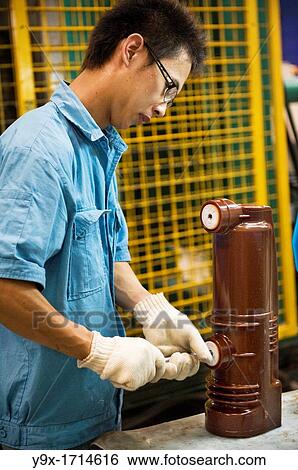 A man pieces together parts in the manufacturing of the switchgears. Shot in a switchgear factory that produces metal-clad draw-out type enclosed switchgears View Large Photo Image Stock Photograph - A man pieces together parts in the manufacturing of the switchgears. Shot in a switchgear factory that produces metal-clad draw-out type enclosed switchgears. Fotosearch
