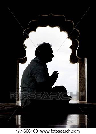 A man praying in a temple Pune, Maharashtra, India View Large Photo Image Stock Image - A man praying in a temple Pune, Maharashtra, India. Fotosearch