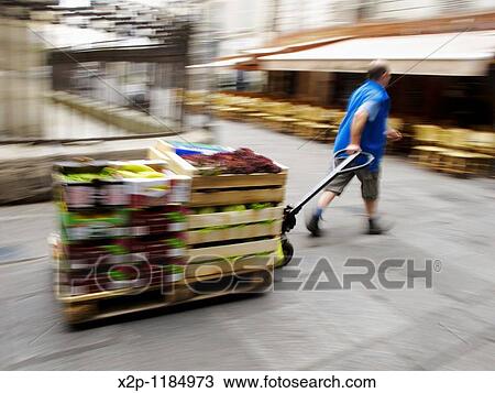 Stock Image - a man preparing the market in Paris. Fotosearch
