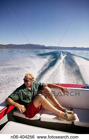 A man sitting in the back seat of power boat on Lake Tahoe, CA. View Large Photo Image Stock Photograph - A man sitting in the back seat of power boat on Lake Tahoe, CA.. Fotosearch