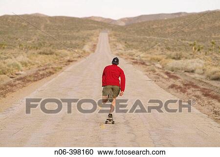 A man skateboarding on a desert road near Lone Pine, California. USA View Large Photo Image Stock Image - A man skateboarding on a desert road near Lone Pine, California. USA. Fotosearch
