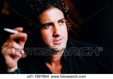A man smoking a cigarette. View Large Photo Image Picture - A man smoking a cigarette.. Fotosearch