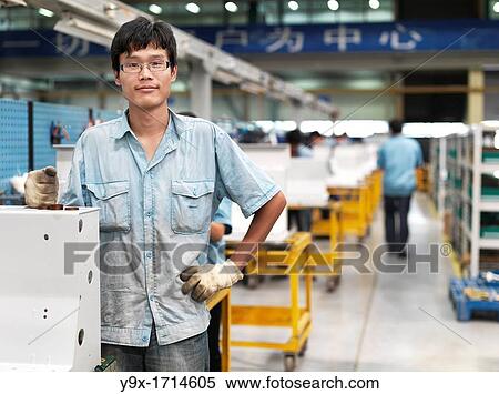 A man standing at a work station where the outer shell of the switchgears are pieced together. View Large Photo Image Stock Photography - A man standing at a work station where the outer shell of the switchgears are pieced together.. Fotosearch