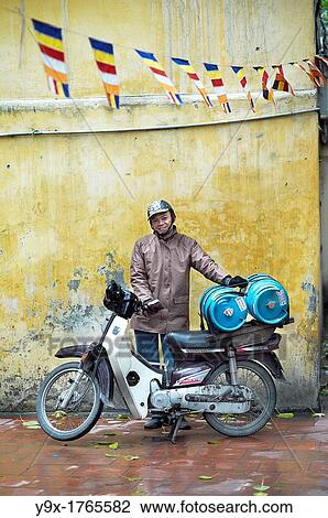 A man transporting gas on his motorcycle in a temple in Vietnam View Large Photo Image Stock Image - A man transporting gas on his motorcycle in a temple in Vietnam. Fotosearch