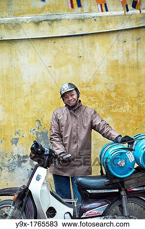 A man transporting gas on his motorcycle in a temple in Vietnam View Large Photo Image Stock Image - A man transporting gas on his motorcycle in a temple in Vietnam. Fotosearch