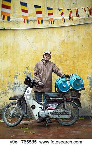 A man transporting gas on his motorcycle in a temple in Vietnam View Large Photo Image Stock Photography - A man transporting gas on his motorcycle in a temple in Vietnam. Fotosearch